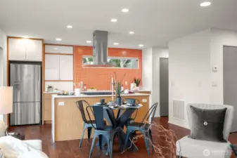 Kitchen features a vibrant tile wall