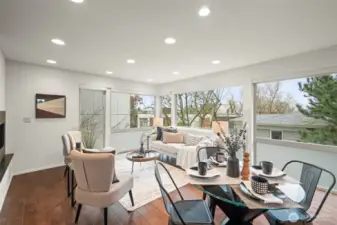 Wall of windows surrounds the living room and kitchen