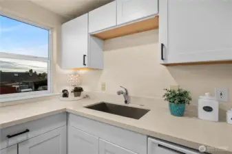 This close up picture shows the newer cabinets and countertops and large