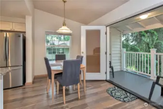 Dining room with double doors to balcony and laminated wood floors.  Great indoor/outdoor living spaces.