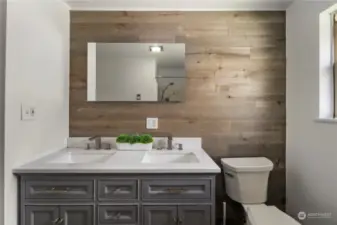 The main bath boasts a stylish accent wall, large vanity and gorgeous countertops.