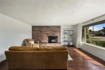 Enter this home and find the warm vinyl plank flooring along with a cozy gas fireplace.