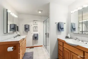 Primary bathroom with double vanity and walk in shower.