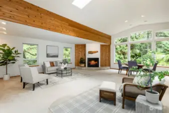 Living room as you enter the home.  Picture windows give feeling of being in a treehouse.  Trim along ceiling is knotty cedar.