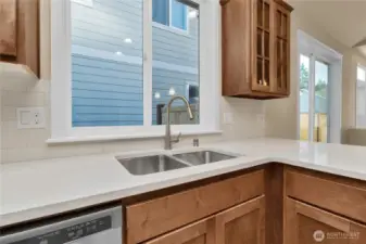 Lovely quartz counters and undermount sink. Photo from similar plan on a different lot for reference only