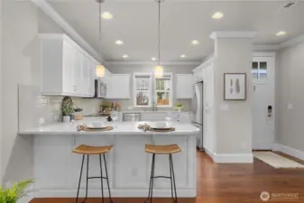 Timeless and sleek kitchen. Notice the beautiful trim work and crown molding!