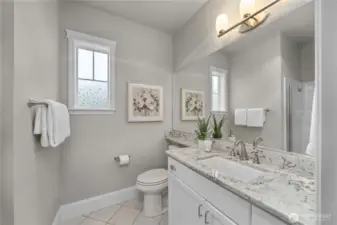 Guest bath with Quartz counters, tile floors, timeless fixtures and beautiful window wraps.
