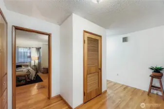 Hallway with hardwood floors and easy access to bedrooms and bath.