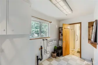 Light-filled laundry room with storage space and convenient access to the 3/4 bath