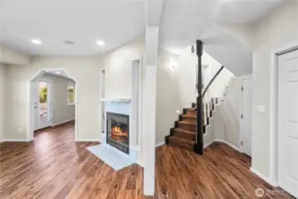 Downstairs opens to a hallway, family room/den space, and SO MUCH STORAGE SPACE
