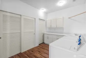 HUGE utility room with TONS of storage, laundry area, and closet with furnace and water heater
