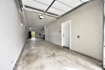 Huge 2 car tandem garage equiped with EV charging station, access to back patio and an extra walk-in storage room.