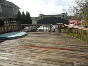 Rear deck with non functioning hot tub.  Off street/Alley parking space for two cars.