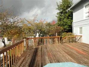 Wood deck, one car garage through trees
