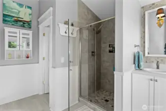 Remodeled primary bath with large, custom-tiled shower