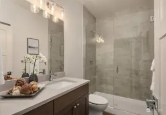 Elegant bath with large tile shower & Euro glass door.