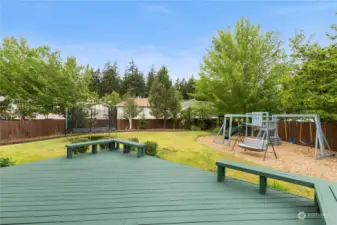Large Fully-fenced in backyard with a large deck.