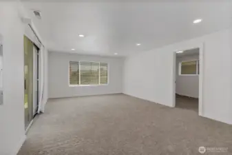 The roomy family room is carpeted for cozy gatherings