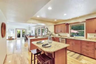 Large island with seating, power & cabinet storage.