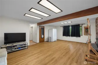 The lower-level family room with newer laminate flooring.