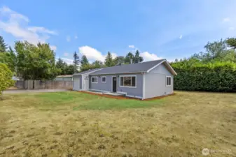 Great yard with mature rhodies, plum trees and pear trees along with a massive backyard laurel hedge for privacy
