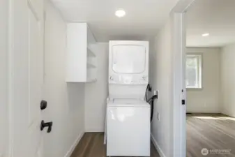 The laundry/ mudroom with shelving and apple storage floor space for another shelf.