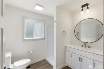Primary bathroom with all new fixtures, cabinets and shower. Carefree living in a home that is new from the studs out!