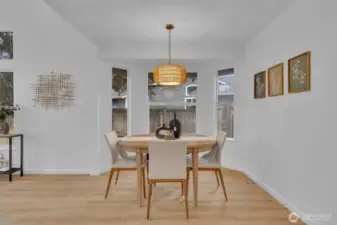 The dining nook is surrounded by windows on three sides, filling the space with natural light throughout the day.