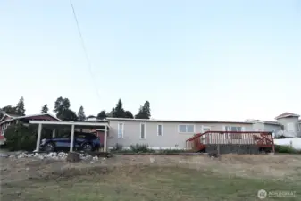 This property features a convenient carport with access to electrical outlets and offers ample parking for up to four vehicles—perfect for households with multiple drivers or frequent guests. Room for your toys like RV or boat!