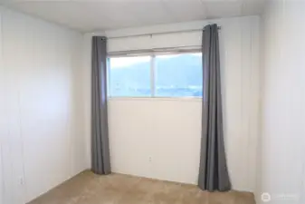 Bedroom three features beautiful lake views, carpeting, and an abundance of natural light throughout. A queen size bed fits perfectly here.