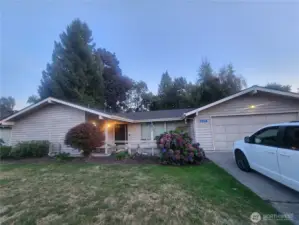 Front of rambler with covered patio and 2-car garage in coveted Rolling Ridge neighborhood