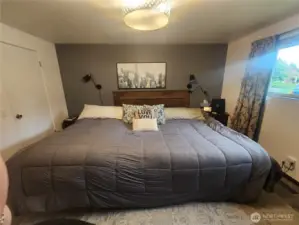 Primary bedroom with large window and en-suite
