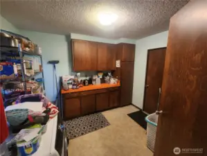 Laundry room, utility room and pantry with a door to go outside and a door to garage