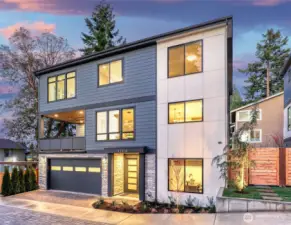 Striking twilight exterior showcases the modern architecture, covered outdoor living, and premium curb appeal of this final Houghton Collection home.