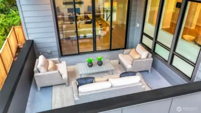 A spacious, year-round covered outdoor living room framed by tree-top outlooks. Complete with ample lounging space, a gas bbq stub, ceiling heater, and speakers...room to dine or entertain, this is an extension of the great room and the perfect place to unwind.