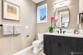 Sleek main-level three-quarter bath featuring a walk-in shower, contemporary finishes, and well-chosen tilework. Ideally located to serve the adjacent office/flex room or guest bedroom.