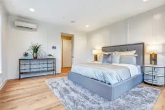 Generously sized primary bedroom, French door entry into a vestibule, elegant painted millwork paneling, and a serene retreat atmosphere. Views to the west of the Olympic Mountains and filtered lake views.