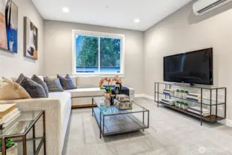 Spacious second-level media room with room for a large sectional, full-wall TV, and gaming or lounge furniture. A perfect flex space for movie nights or casual hangouts.