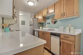 Kitchen features updated cabinets, countertops, new refridgerator and dishwasher.