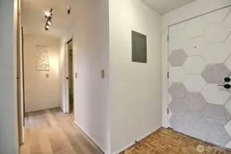 Hallway leads to the primary bedroom and full bath.