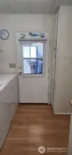 Laundry with exit door. Perfect mudroom with sink
