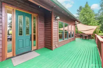 Front door and deck with seating area.