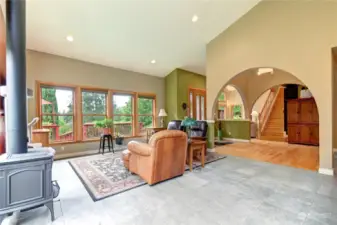 Great room photo with more windows facing the beautiful front landscaped yard. You can see how open this home is with this view.