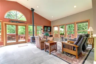 View from the foyer toward the great room and french doors to side deck. The natural light in this home is stunning.