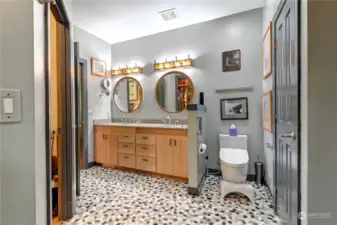 View of primary bath from the shower. Walk in closet to the left, additional closet space to the right.