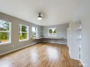 Upstairs office with built in shelving and work station overlooking lake.