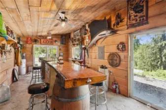 Covered outdoor BBQ area overlooks barn and arena
