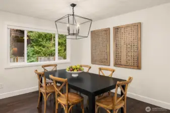 This cozy dining nook includes rear views of the productive and lush property grounds.