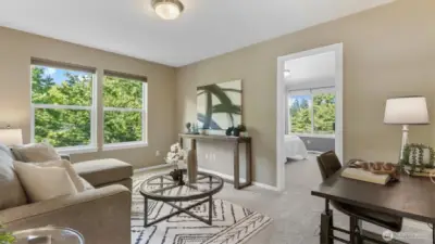 Upstairs, a spacious loft offers the perfect retreat for work or play