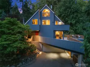 This charming home feels like a treehouse retreat—nestled among the trees yet flooded with natural light thanks to so many windows.